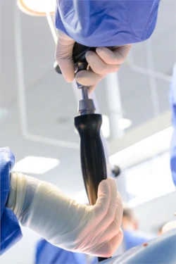 Image of surgeon with instrument in hand